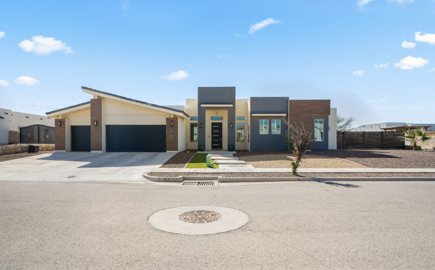 Newer single-story Horizon City home with a three-car garage under a blue sky